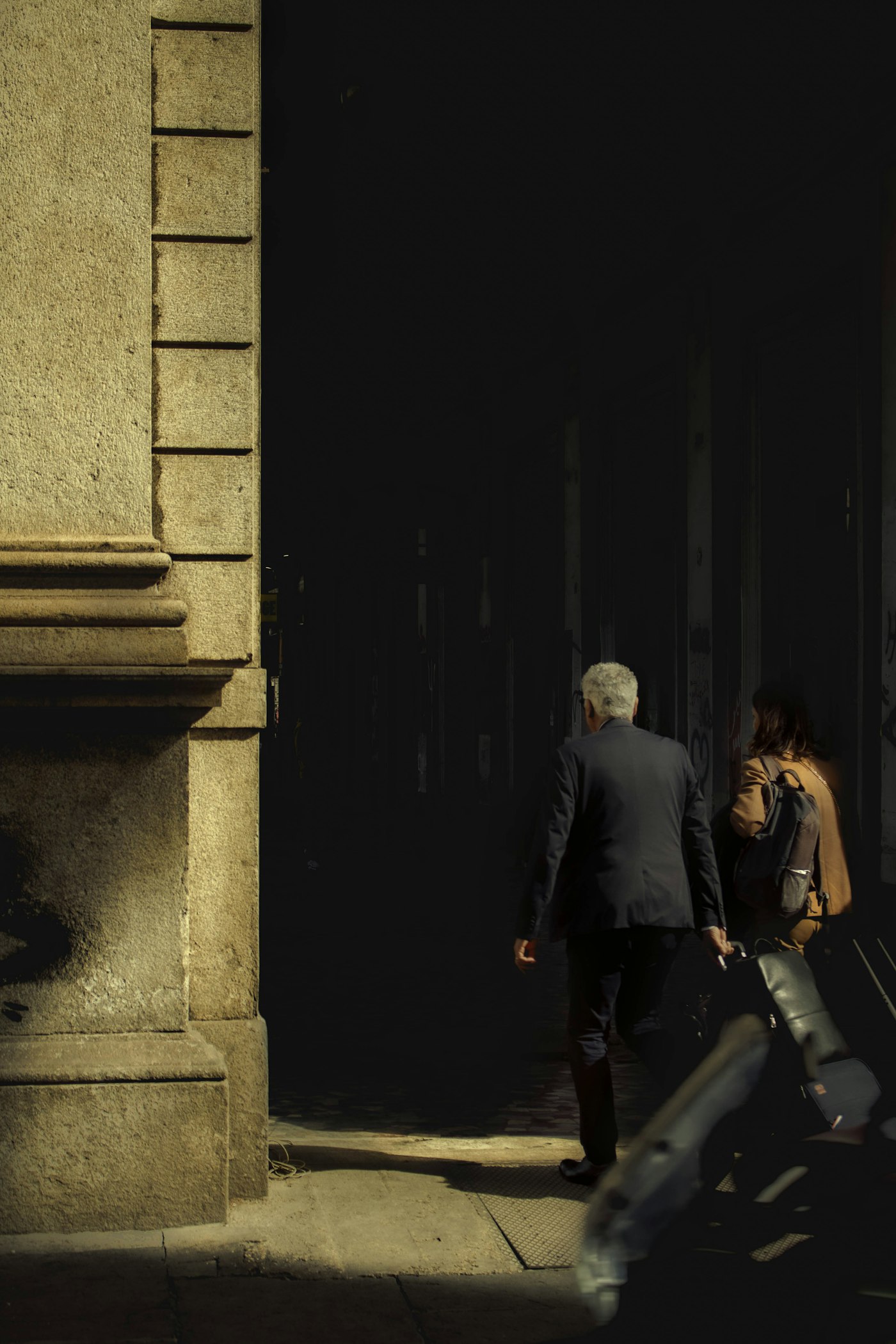 Two colleagues walking together through a city street