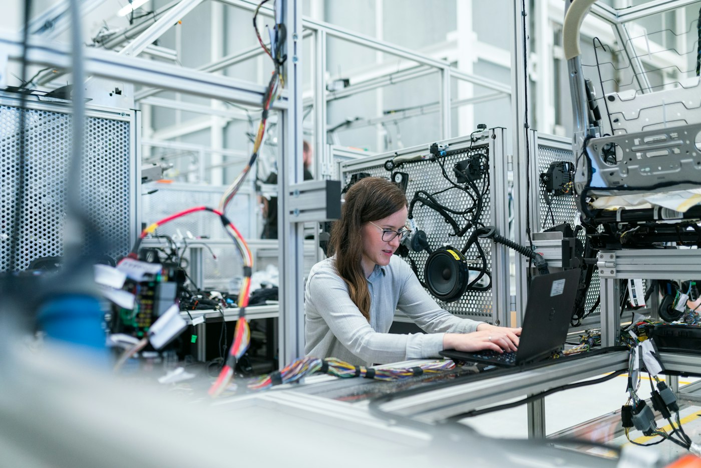Engineer working on a laptop on a factory floor